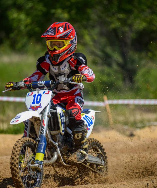 KHABAROVSK, RUSSIA - june 16, 2019 : Racer child on motorcycle participates in motocross cross-country in flight, jumps and takes off on springboard against sky. Concept active extreme rest teenager